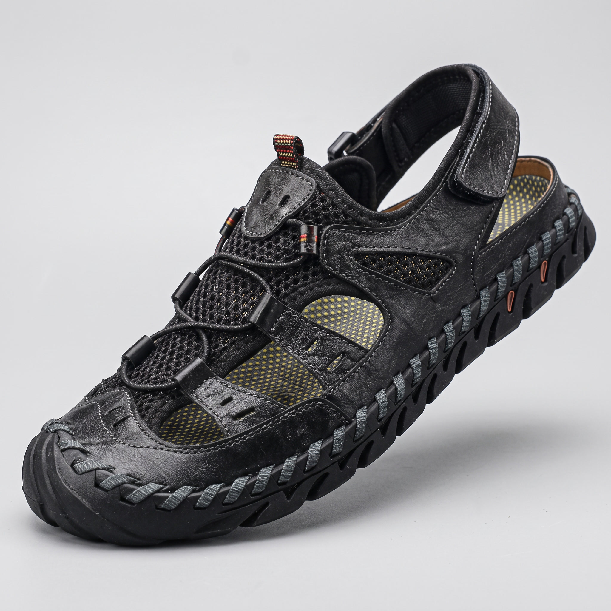 Three-quarter front view of the black closed-toe sandal