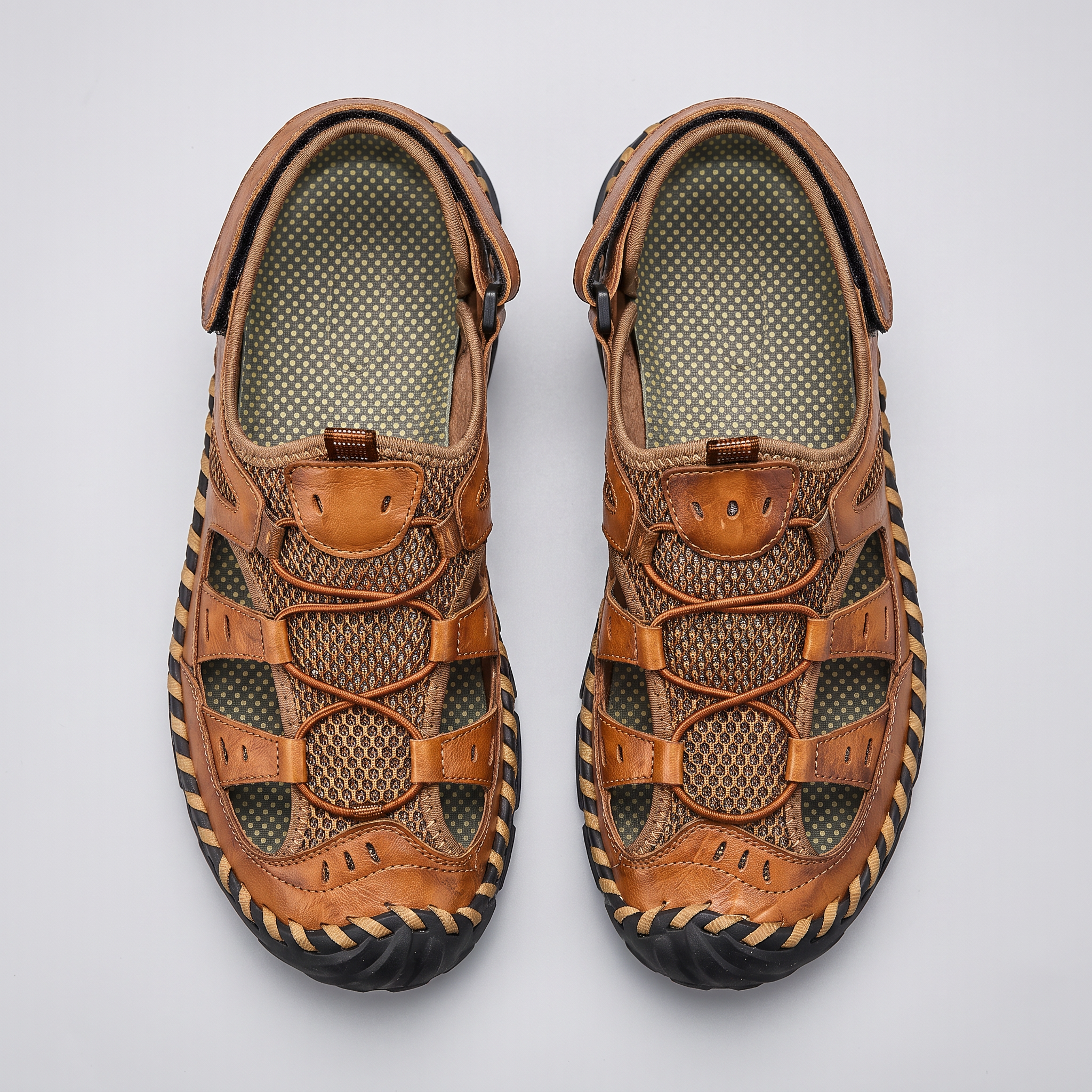 Men's closed-toe leather and mesh sandals in tan, top-down pair