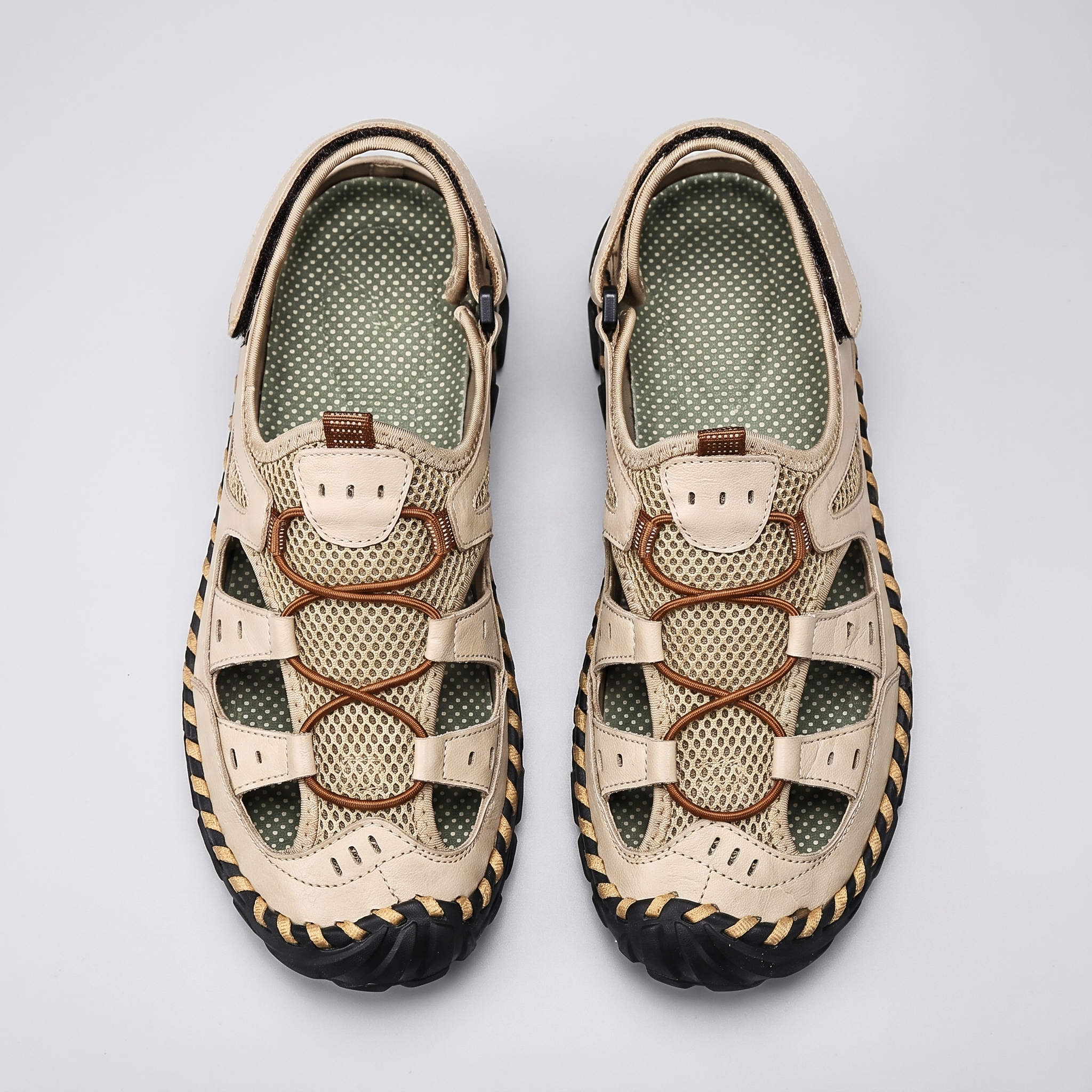 Men's closed-toe leather and mesh sandals in cream, top-down pair
