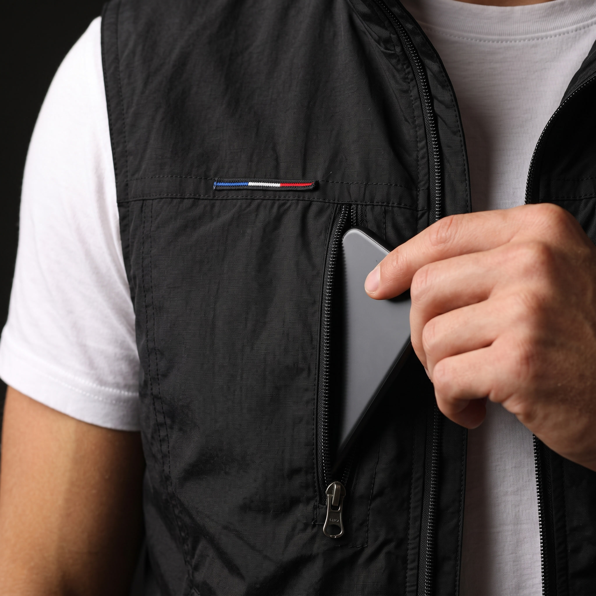 Phone going into a zipped chest pocket