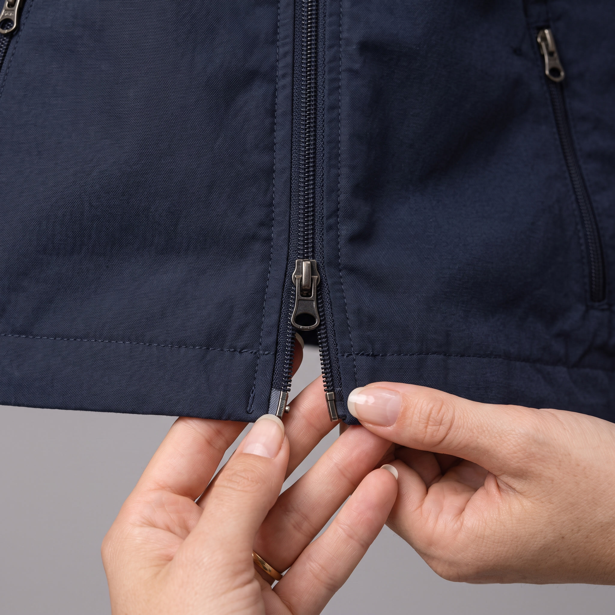 The second zip pull at the hem - the front zip runs two ways